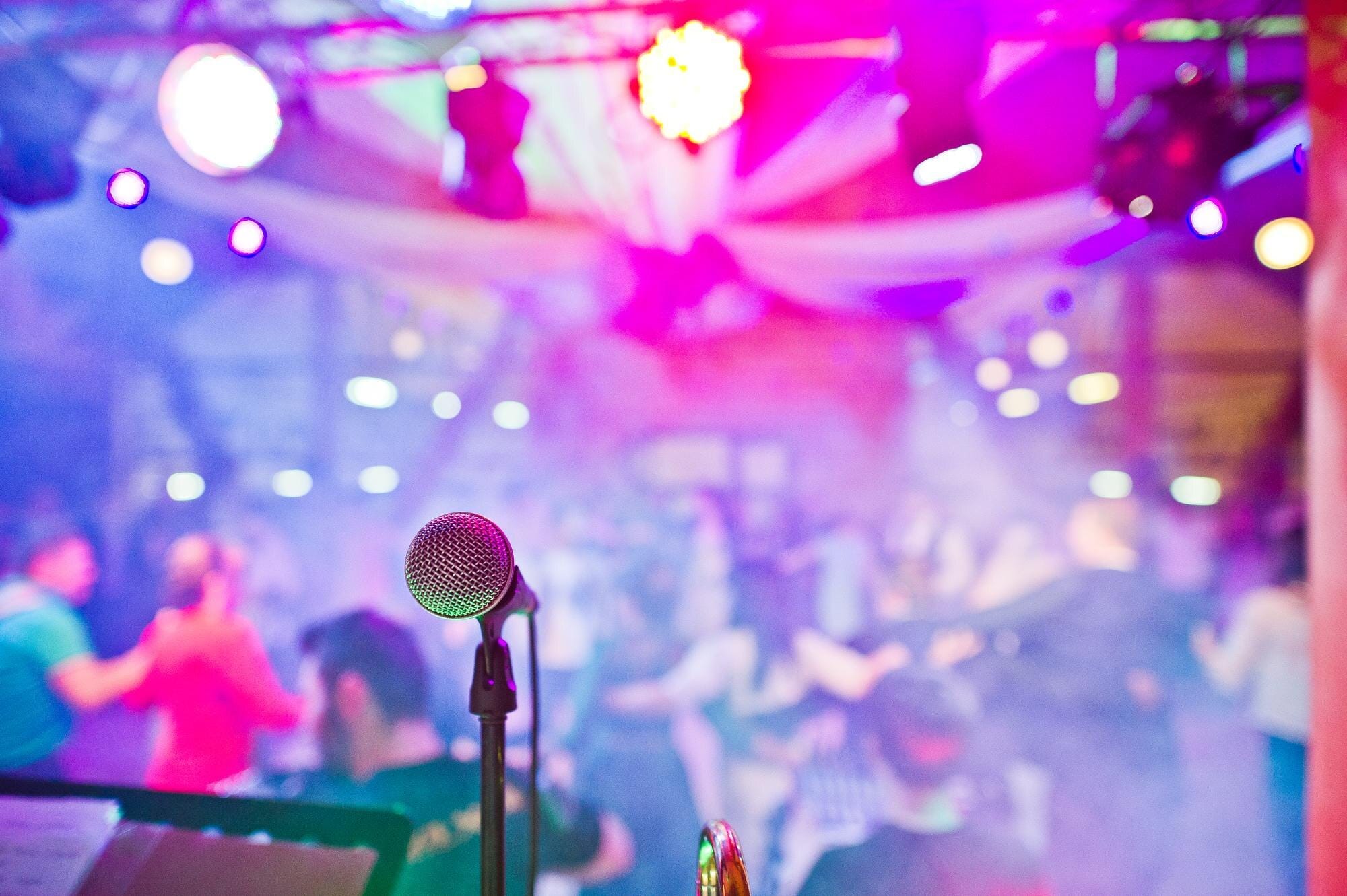 Commercial karaoke system and microphones set up at the end of a bar