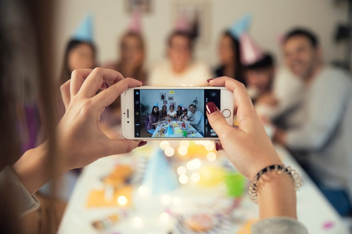 Guests sharing photos at a lively event, capturing memories together