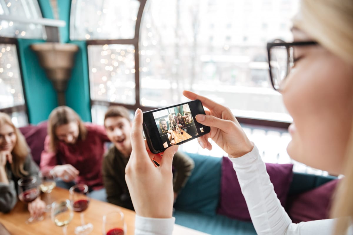 Event organizers and guests viewing a shared online photo gallery on their mobile devices