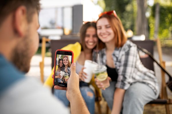 Guests taking photos and videos at a wedding reception with their smartphones
