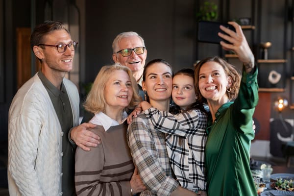 Three generations of family talking together at a home baby shower celebration